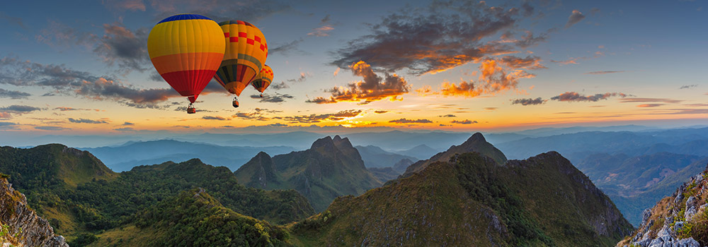 hot air balloons over mountains
